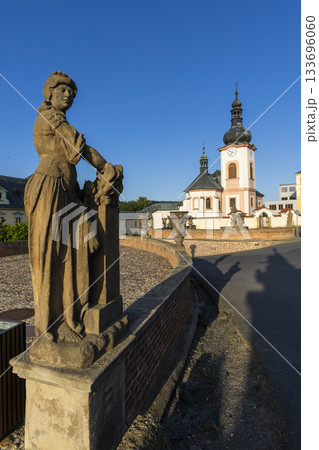 Baroque statue and Church of Saint John the Baptist Manetin 133696060