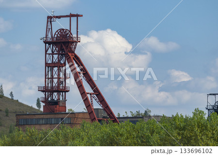 Mine headframe standing in Zacler, Czechia with blue sky Mine headframe standing in Zacler, Czechia with blue sky 133696102