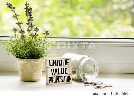 Wooden cubes create the word UVP, an abbreviation of a unique value proposition 133696603