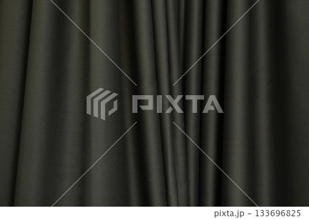Dark brown curtains, folded in wavy, uneven, decorate the house for use as a background image. Dark brown curtains, folded in wavy, uneven, decorate the house for use as a background image. 133696825