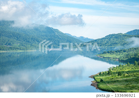 夏の野反湖に映る青空と緑の山並みが美しい静寂の湖面風景（群馬・中之条町） 133696921