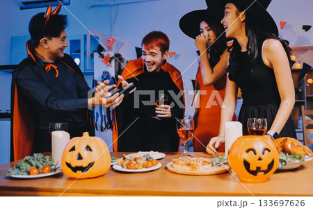 Joyful office Halloween party with coworkers in costumes, celebrating with drinks and laughter, fostering teamwork and festive spirit 133697626