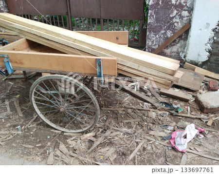 pile of wooden planks loaded on trolley in carpenter workshop 133697761