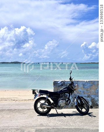 Motorcycle by Tropical Ocean and Long Bridge 133698518