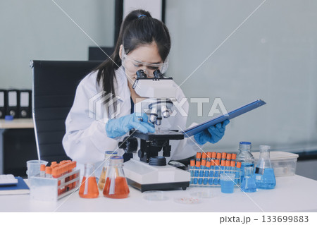 Portrait, science and happy woman on laptop in lab to research chemistry, test or innovation. Microscope, scientist and face of medical doctor in goggles for microbiology, healthcare or pharma study Portrait, science and happy woman on laptop in lab to research chemistry, test or innovation. Microscope, scientist and face of medical doctor in goggles for microbiology, healthcare or pharma study 133699883