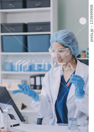 Portrait, science and happy woman on laptop in lab to research chemistry, test or innovation. Microscope, scientist and face of medical doctor in goggles for microbiology, healthcare or pharma study 133699906