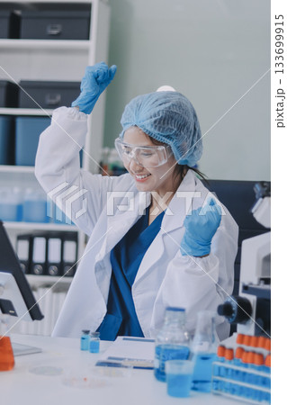 Portrait, science and happy woman on laptop in lab to research chemistry, test or innovation. Microscope, scientist and face of medical doctor in goggles for microbiology, healthcare or pharma study 133699915