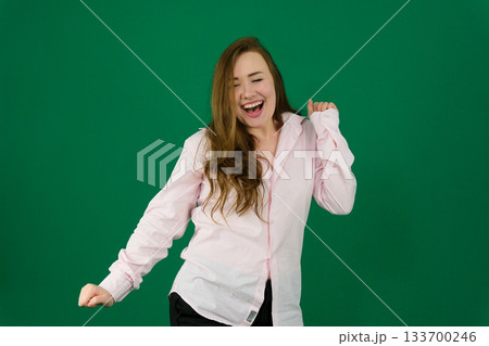 Glad white girl in sunglasses has a good time in studio. Portrait of amazing curly woman dancing on purple background. Glad white girl in sunglasses has a good time in studio. Portrait of amazing curly woman dancing on purple background. 133700246