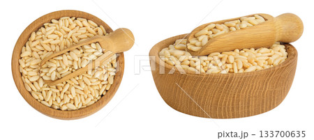 Shelled European pine nuts in wooden bowl and scoop isolated on white background. Top view. Flat lay Shelled European pine nuts in wooden bowl and scoop isolated on white background. Top view. Flat lay 133700635