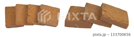 Brown cheese. Norwegian brunost isolated on white background. Top view. Flat lay 133700656