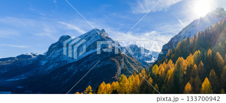 Panoramic view of Dolomite mountain peaks in day light. Early winter scene with snow-covered summits, captured in high resolution, perfect for large fine art prints. Panoramic view of Dolomite mountain peaks in day light. Early winter scene with snow-covered summits, captured in high resolution, perfect for large fine art prints. 133700942
