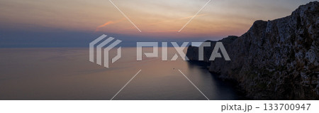 Dramatic sunset over the lighthouse of Cap de Formentor, Mallorca. The orange glow of the Mediterranean Sea captured from high cliffs in stunning high resolution. perfect for fine art prints. Dramatic sunset over the lighthouse of Cap de Formentor, Mallorca. The orange glow of the Mediterranean Sea captured from high cliffs in stunning high resolution. perfect for fine art prints. 133700947