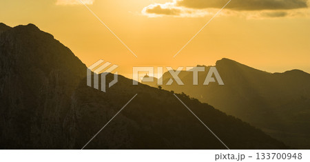 Golden sunset over the cliffs of Cap de Formentor, Mallorca, Spain. Breathtaking Mediterranean landscape with sun rays over the rocky coast, captured in stunning high resolution. Golden sunset over the cliffs of Cap de Formentor, Mallorca, Spain. Breathtaking Mediterranean landscape with sun rays over the rocky coast, captured in stunning high resolution. 133700948