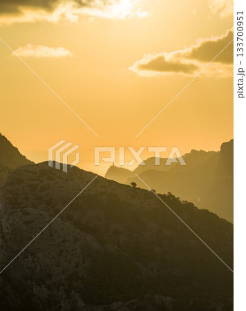 Golden sunset over the cliffs of Cap de Formentor, Mallorca, Spain. Breathtaking Mediterranean landscape with sun rays over the rocky coast, captured in stunning high resolution. 133700951