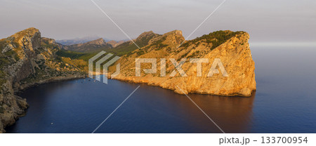 Golden sunset over the cliffs of Cap de Formentor, Mallorca, Spain. Breathtaking Mediterranean landscape with sun rays over the rocky coast, captured in stunning high resolution. Golden sunset over the cliffs of Cap de Formentor, Mallorca, Spain. Breathtaking Mediterranean landscape with sun rays over the rocky coast, captured in stunning high resolution. 133700954