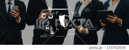 Business professionals collaborating on cybersecurity measures with digital icons and shield graphics in a corporate environment Trope 133702656