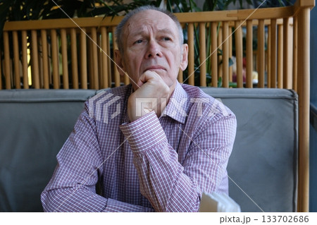 Senior man, home and thinking in chair with memories or reflection on retirement, break and chill. Thoughts, calm and relax or peaceful as elderly person with mindfulness, perspective and nostalgia 133702686