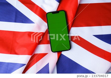 Green smartphone phone chromakey screen National symbol of Great Britain. Mock up advertisement template UK wave British fabric flag background. Copy space for your text. Independence Green smartphone phone chromakey screen National symbol of Great Britain. Mock up advertisement template UK wave British fabric flag background. Copy space for your text. Independence 133704017
