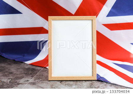 Empty white paper frame National symbol of Great Britain. Mock up advertisement template British wave UK fabric flag background. Copy space for your text. Independence 133704034