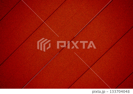 Red plastic texture background with diagonal parallel lines 133704048
