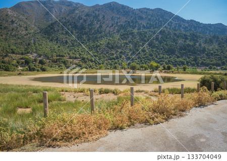 Small drying lake in mountain village Omalos in White Mountains of Crete 133704049