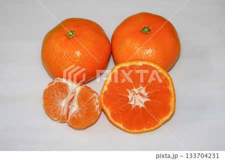fresh tangerines on a white wooden background. 133704231