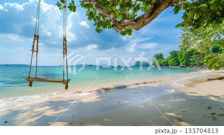swing hanging from the branch of an overgrown palm tree on a beach in thailand, offering a serene and picturesque spot for relaxation by the sea. the background features calm waters with gentle wave swing hanging from the branch of an overgrown palm tree on a beach in thailand, offering a serene and picturesque spot for relaxation by the sea. the background features calm waters with gentle wave 133704813