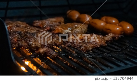 Grilled Meat and Sausages on Hot Barbecue Grill 133704944