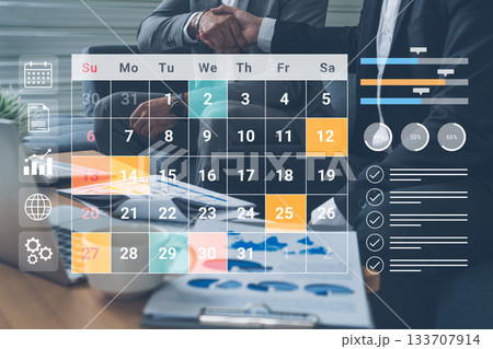 Business Partnership Meeting with Calendar Planning and Data Analysis on Desk featuring Charts, Graphs, and Professional Documents Gantry Business Partnership Meeting with Calendar Planning and Data Analysis on Desk featuring Charts, Graphs, and Professional Documents Gantry 133707914