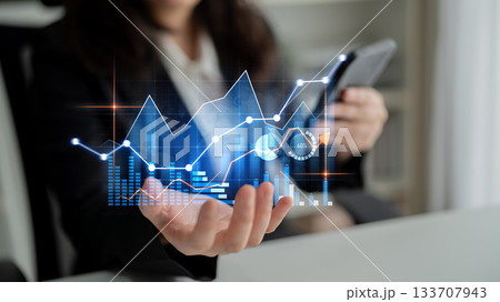 Business professional analyzing finance data with digital graphs and presentation on mobile device in modern office environment Scalp Business professional analyzing finance data with digital graphs and presentation on mobile device in modern office environment Scalp 133707943