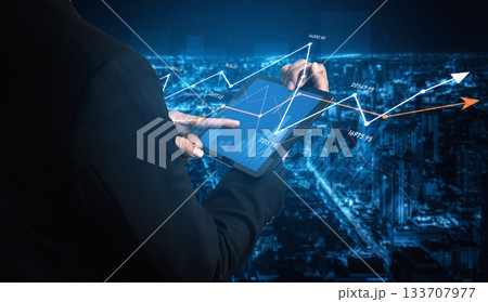 Business Professional Analyzing Data Trends on Tablet Device at Night with Cityscape Background and Graph Overlays for Financial Insights Scalp Business Professional Analyzing Data Trends on Tablet Device at Night with Cityscape Background and Graph Overlays for Financial Insights Scalp 133707977
