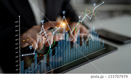 Business professional analyzing stock market data on a tablet screen with digital graphics displaying financial trends in a modern office environment Scalp Business professional analyzing stock market data on a tablet screen with digital graphics displaying financial trends in a modern office environment Scalp 133707979