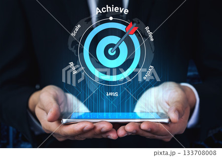 Business Professional Holding Smartphone with Digital Target Concept for Achieving Goals, Scaling Strategies, Refining Processes, and Evolving Success Gantry Business Professional Holding Smartphone with Digital Target Concept for Achieving Goals, Scaling Strategies, Refining Processes, and Evolving Success Gantry 133708008