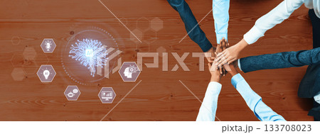 Team Collaboration and Innovation Concept with Abstract Brain Graphic and Diverse Hands Stacked on Wooden Table Surface Trope 133708023