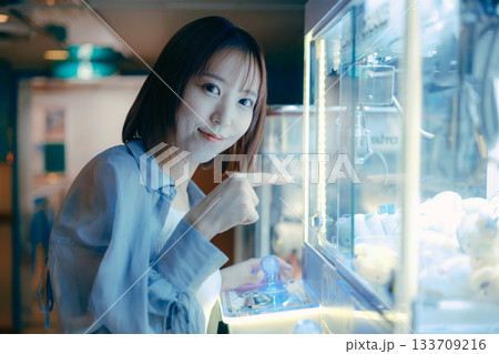 彼氏目線で見つめるクレーンゲームに夢中な20代女性 彼氏目線で見つめるクレーンゲームに夢中な20代女性 133709216