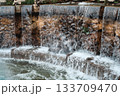 Cascading stone waterfall feature with flowing water 133709470