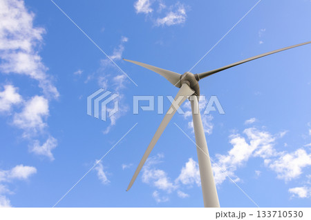 Windmill with huge blades in the sky, sustainable energy source Windmill with huge blades in the sky, sustainable energy source 133710530