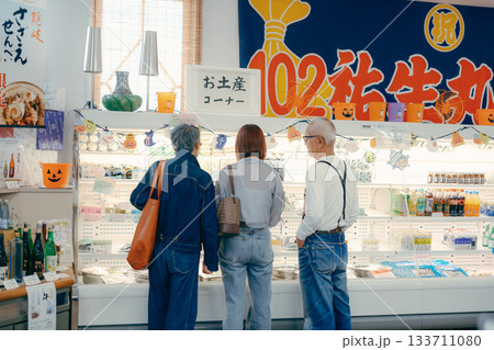 店内で商品を見ながら話す三人の姿 店内で商品を見ながら話す三人の姿 133711080