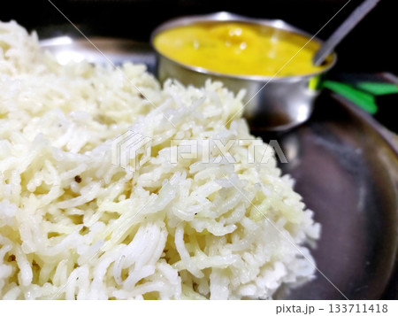 Traditional Indian Kadhi with Steamed Rice Served in Steel Plate Traditional Indian Kadhi with Steamed Rice Served in Steel Plate 133711418