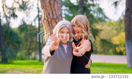 Playful senior friends joking and having fun together outdoors Playful senior friends joking and having fun together outdoors 133712192