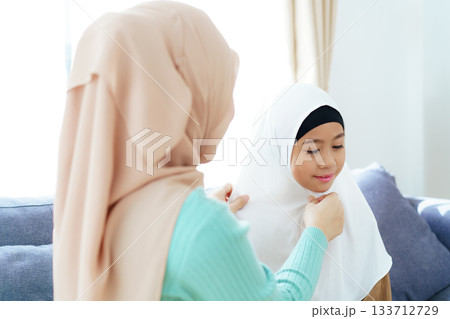 Asian muslim family's lifestyles concept. Woman get her daughter dressed. Asian muslim family's lifestyles concept. Woman get her daughter dressed. 133712729