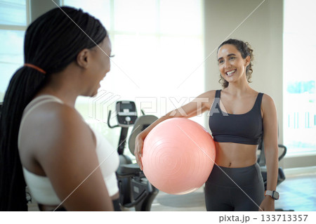 Healthy sportswomen practicing yoga exercise. 133713357