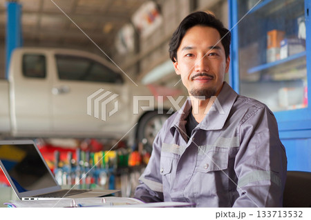 Repairman portrait in garage. Repairman portrait in garage. 133713532