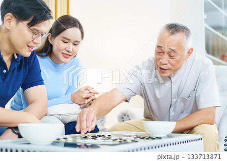 Encouraging the elderly to play brain-stimulating games like this helps prevent memory-related illnesses such as dementia. 133713871