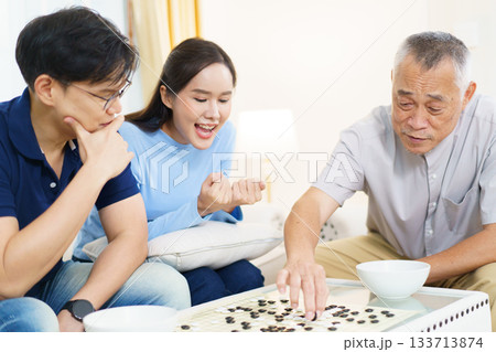 Encouraging the elderly to play brain-stimulating games like this helps prevent memory-related illnesses such as dementia. 133713874