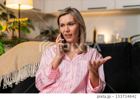 Adult woman angry smartphone call argues frowns sharp gesture rejects offer blocks spam scam caller 133714642