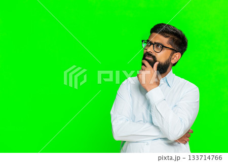 Indian man touching chin with thoughtful face showing idea development thinking process chroma key 133714766