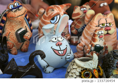 Souvenir figurines of a rabbit, cats and other animals in the gift shop. Souvenir figurines of a rabbit, cats and other animals in the gift shop. 133716454