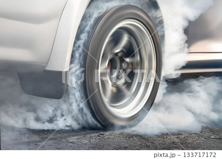 Drag racing car is burning tires at start line. Drag racing car is burning tires at start line. 133717172