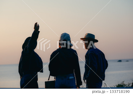 夕景の海を眺める親子3人のシルエット 夕景の海を眺める親子3人のシルエット 133718190